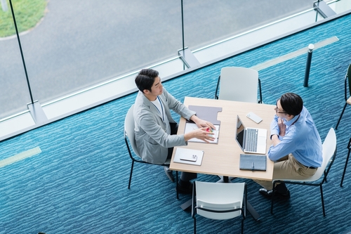 Two,Businessmen,Having,A,Meeting,In,An,Office,[photo,Courtesy